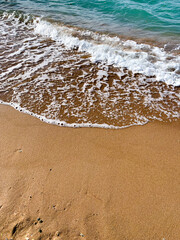 Sand on the beach with a sea wave