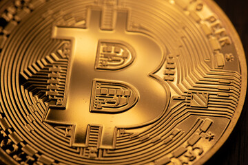 Golden bitcoin coin closeup. Bitcoins. Physical bit coins. Digital currency. Cryptocurrency mining...