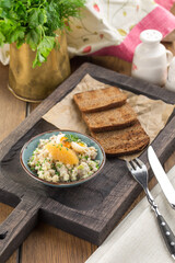 Forshmak Jewish appetizer with herring fish and wholegrain rye bread on wooden table
