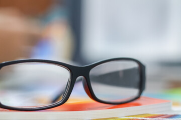 The glasses placed on the desk are pre-made glasses for working in order to increase the field of view for designers who need work eyesight. Concept of wearing eyeglasses to increase the visual acuity