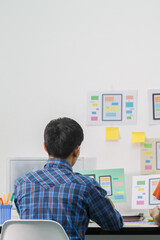 Obraz premium Smooth Focus,A team of UI UX web designers are working together to develop a mobile responsive website with UI UX Front End Designer Previewing. Website development concept UI UX front end designer