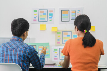 Web designers are working together to develop responsive website gear with UI UX Front End Designer...