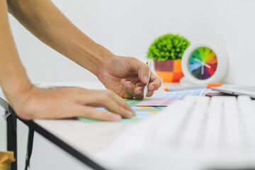 Web designers are working together to develop responsive website gear with UI UX Front End Designer...