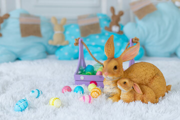 easter concept, bunny and easter colorful eggs on the bed