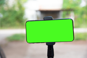 Close up smartphone with green screen.