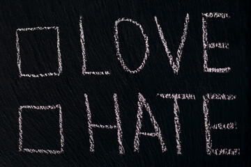 Writing in chalk on a rough board or asphalt love hate with checkmark option. The concept of...