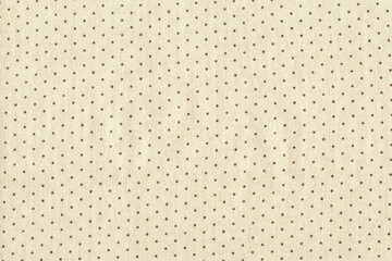 The texture of natural coarse cotton fabric in light color with polka dots. Abstract monochrome background of delicate fabric.