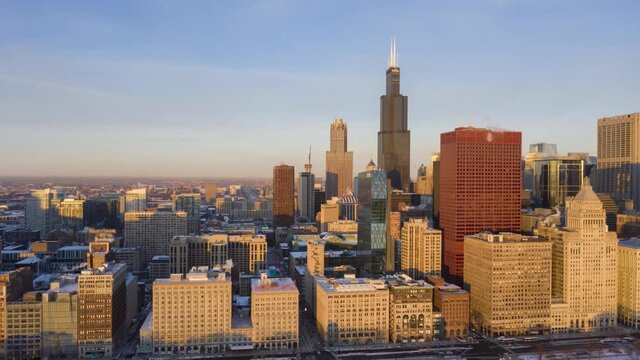 Urban Skyline of Chicago Loop at Sunrise in Frosty Winter Morning. Golden Hour. Aerial Hyper Lapse, Time Lapse. United States of America. Drone Flies Sideways