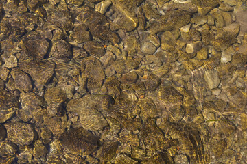 Adriatic sea water surface with pebbles at the seabed