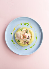 Fillet of white fish on a pillow of mashed potatoes.
