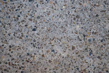 gray concrete surface with inclusions of stones