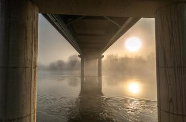 sunrise by the foggy river