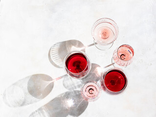 Wine of different varieties on light concrete background. Many different glasses of wine. Wine...