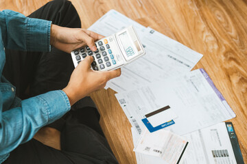 Top view man sitting on the floor stressed and confused by calculate expense from invoice or bill,...