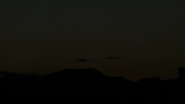 Day to night sunset orange sky silhouet mountains time lapse
