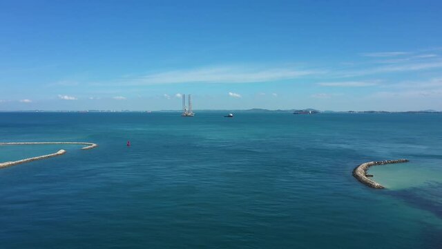 Drone shot of tug pulling oil rig, Singapore