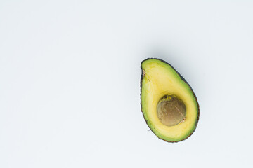 avocado on  the wright of a white board. Empty space