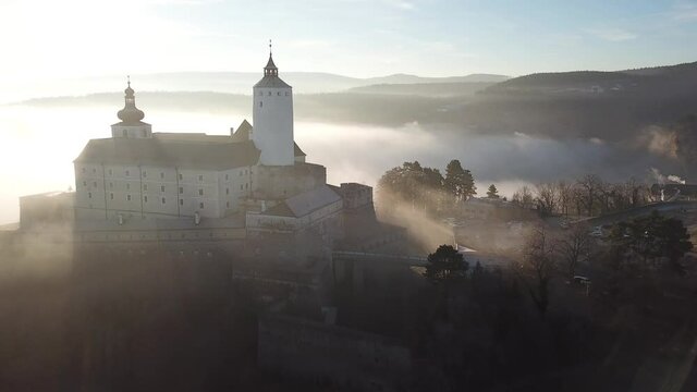 Cinematic morning aerial drone flyby footage of the charming historical quaint old medieval European Burg Forchtenstein Castle in Burgenland Austria