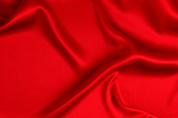 Red silk or satin luxury fabric texture can use as abstract background. Top view