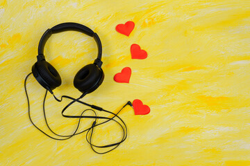 black headphones on a yellow background love for music. Flatlay. copyspace