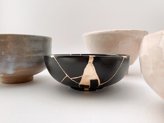 Black kintsugi bowl with gold scars, the beauty of being different. Gold scars and Japanese raku...