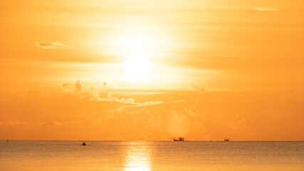 Golden dawn, early morning, sun rising up and covered whole sky and sea with gold color.