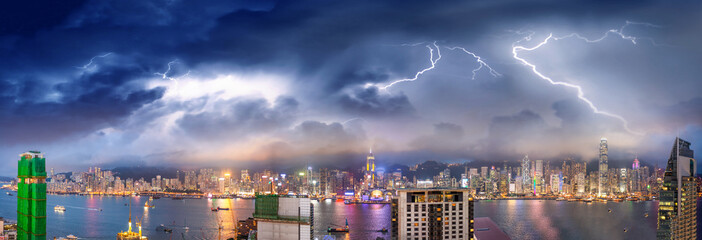 Amazing night panoramic view of Hong Kong skyline from Kowloon Tower with storm approaching