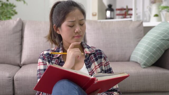 student thinking about what to write in journal