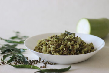 Stir fried Bottle gourd and green gram. A dish made with chopped vegetables and pulsed grated coconut with shallots, green chillies, turmeric and curry leaves in coconut oil
