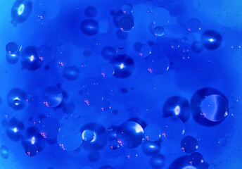 Blue background. An abstraction. Oil circles on the water