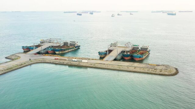 Drone shot of empty cargo ships moored, Singapore