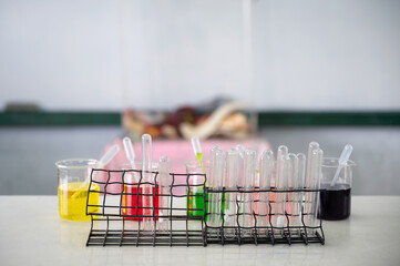 Set of test tube and colorful beaker and experimental substance on the desk at experiment laboratory