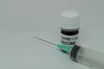 a vaccine for the covid pandemic and a syringe 