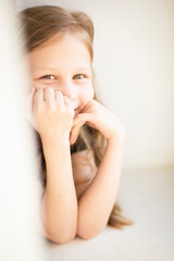 Happy childhood. Emotional portrait of a child in pastel colors, in sunlight, selective focus