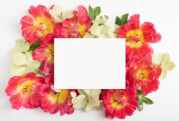Floral flat lay with fresh tulips and blank card
