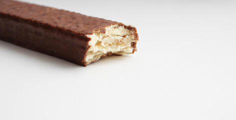 Bitten sweet chocolate waffles isolated on white background. place for text. Bitten chocolate bar
