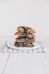 Stack of freshly baked oat blueberry scones on white plate, close up. Sweet food with natural ingredients. Vegan gluten free pastry.