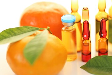 Vitamin C in ampoules. solution for injection.Strengthening immunity and health. ampoules with vitamin c and citrus fruit on a white background. 