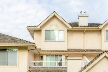 The top of the house or apartment building with nice window.