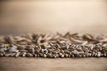 Close up of winter rye and oat seeds on wooden table