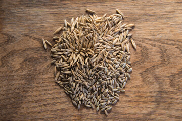 Close up of winter rye and oat seeds on wooden table