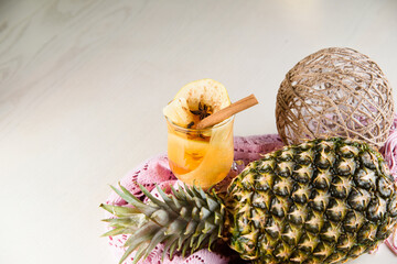 Mulled wine, grog and punch hot alcohol drinks on the table with seasonal decoration: pineapple,...
