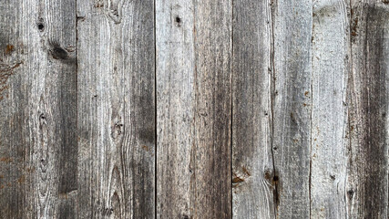 Old gray brown wood background made of dark natural wood in grunge style. The view from the top. Natural raw planed texture of coniferous pine. The surface of the table to shoot flat lay. Copy space.