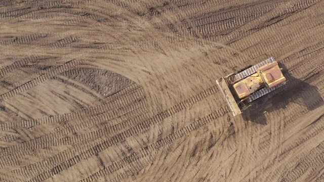 Bulldozer working on Dirt in the Construction Site