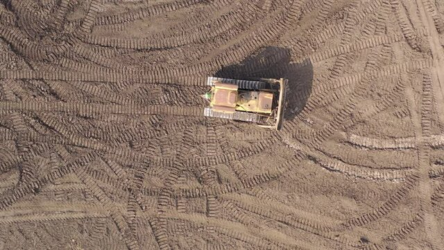 Bulldozer working on Dirt in the Construction Site