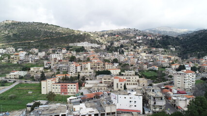 Naklejka premium Aerial view of the city. Middle east region. Beauty of Lebanon. Houses near the valley and mountains. Spring season. Best travel destinations. Vacation and fun