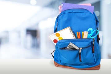 Classic school backpack with colorful school supplies and books