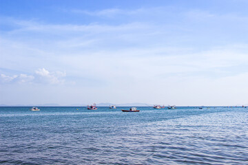 Traditional thai fishing boat floating in the sea of thailand near koh larn on day the bright sky.