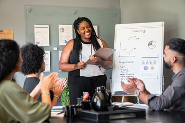 black business woman giving flipchart presentation in the office. . - Powered by Adobe
