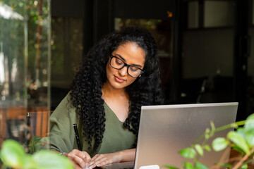 black business woman taking notes with pen in the office. .